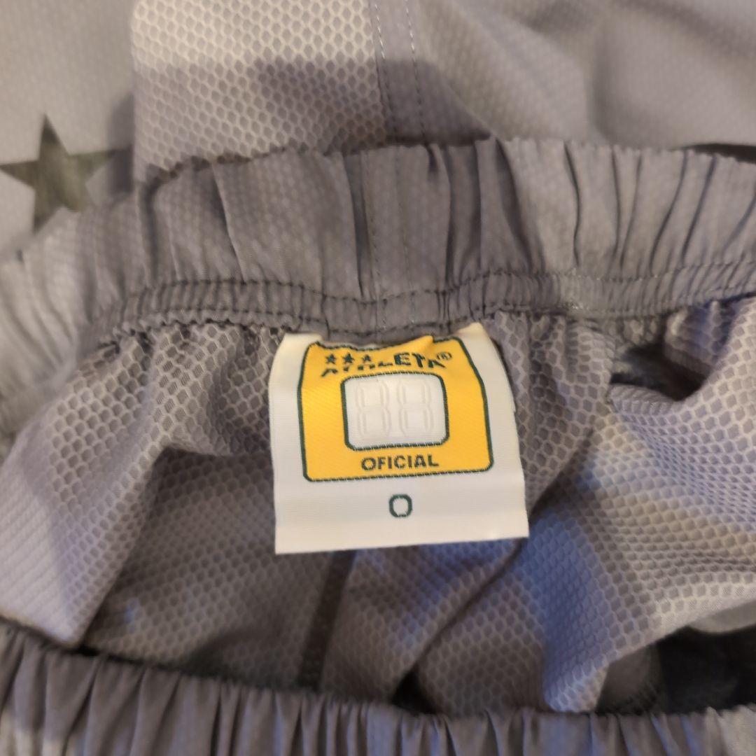 ATHLETA グレー ピステ・ウィンドブレーカー